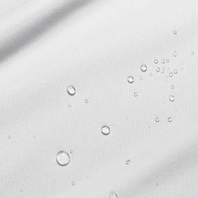 Close-up image of water droplets on a white mattress protector