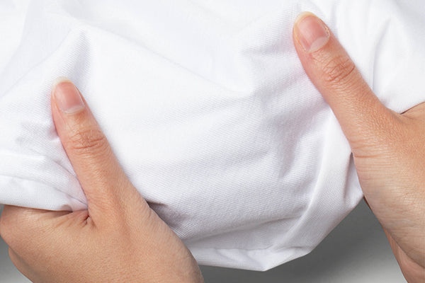 Image of two hands holding Bamboo protector fabric