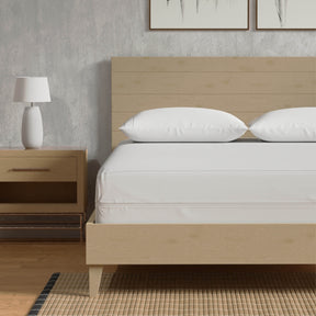 Image of a Bamboo Mattress Protector on a tan bed with two pillows covered with Bamboo Pillow Protectors 