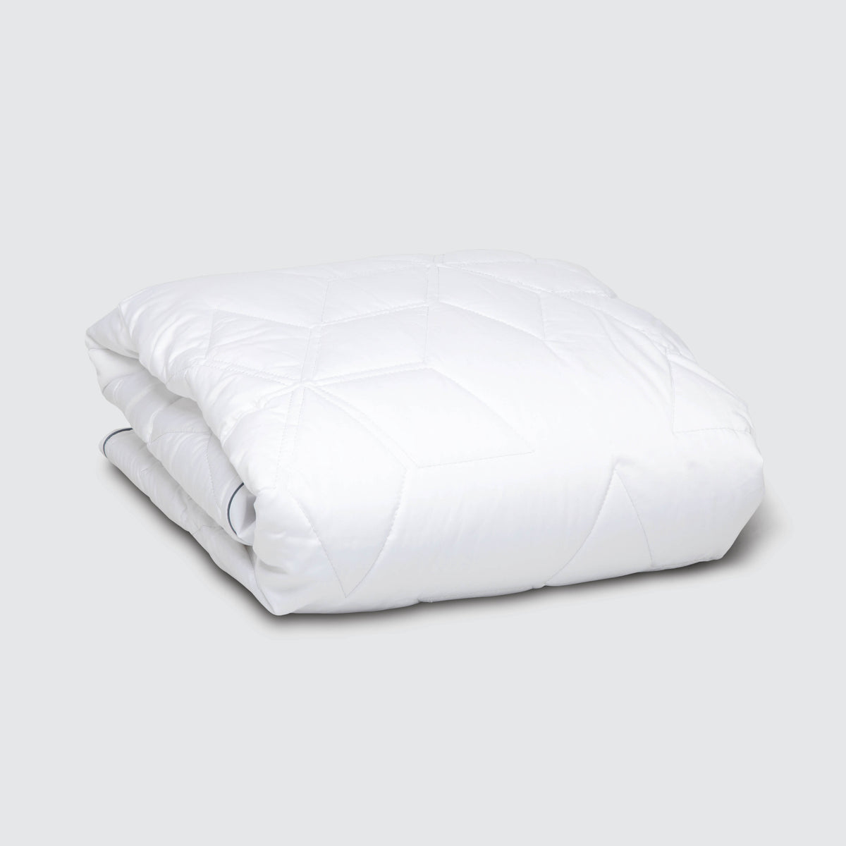 Image of a folded Cooling Quilted Mattress Protector on a plain white background