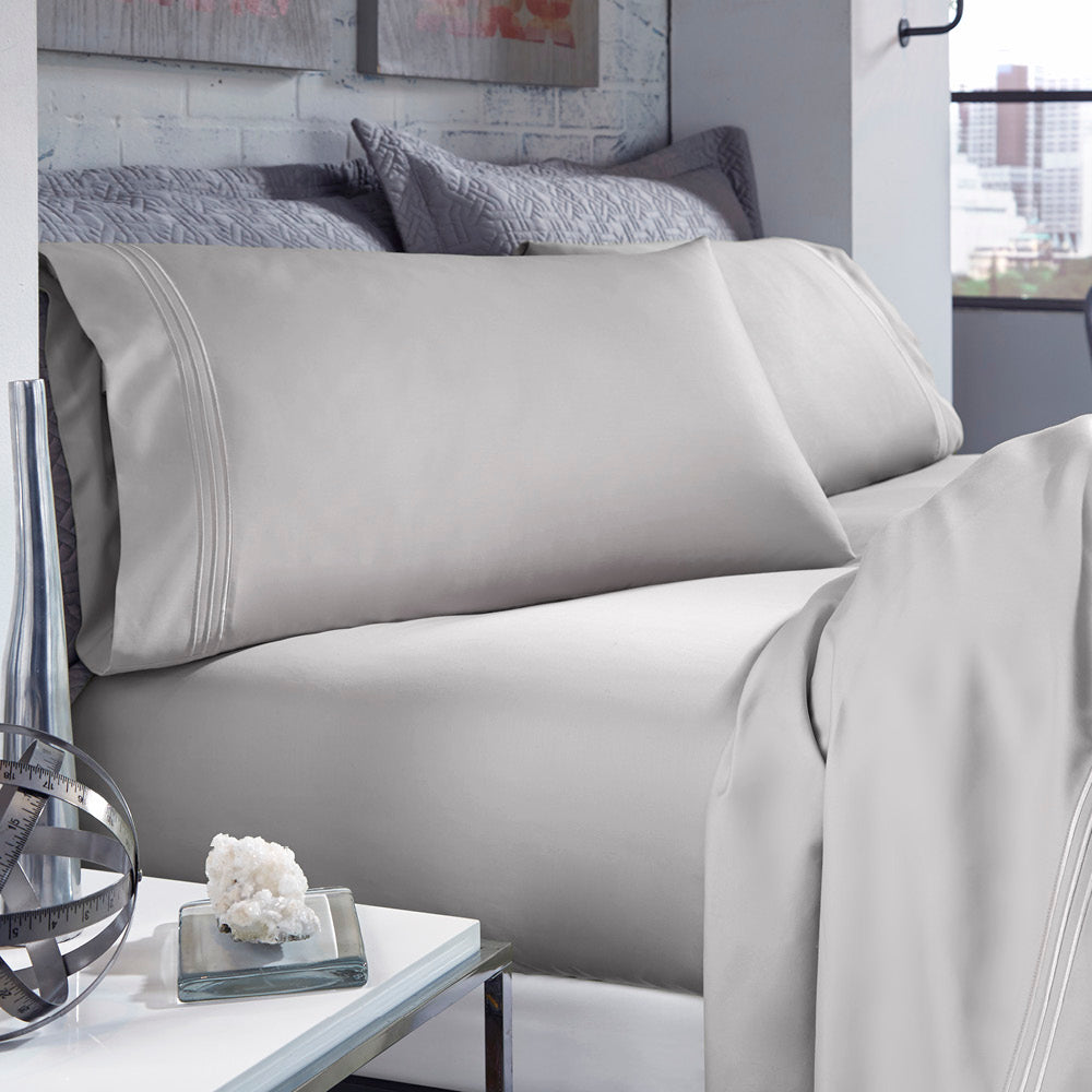 Image of Dove Gray Recovery Cotton Sheets on a bed