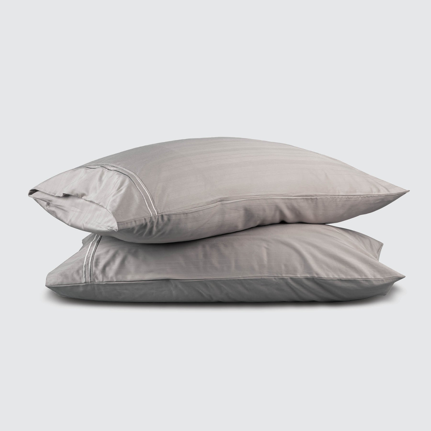 Image of two pillows stacked on top of one another with a Dove Gray Bamboo Rayon Pillowcase on each