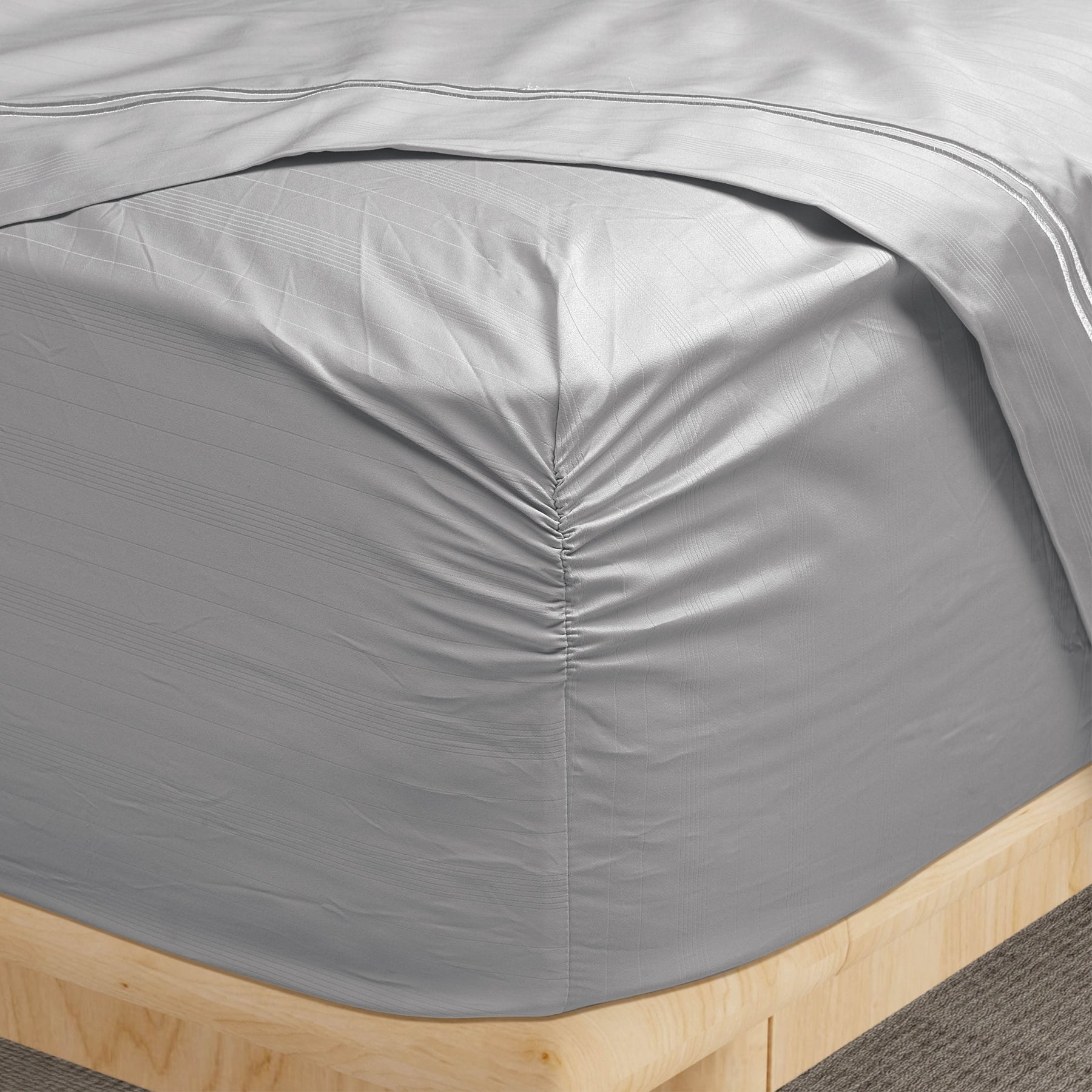 Image of a corner of a Dove Gray Bamboo Rayon fitted sheet showcasing the Precision-Fit® Corner