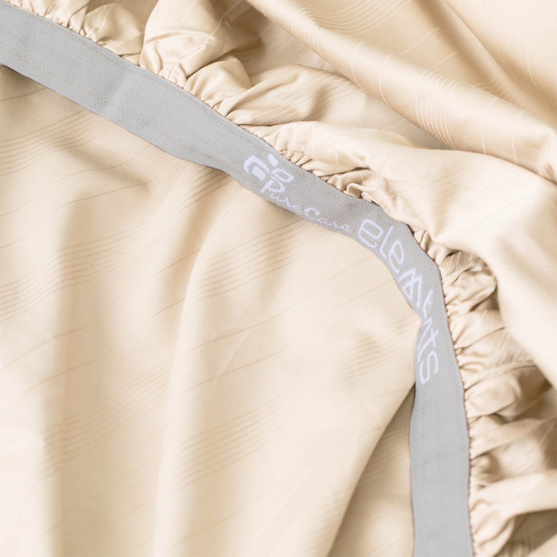 Image showcasing the Precision-Fit® elastic band on the bottom of an Ivory Bamboo Rayon fitted sheet