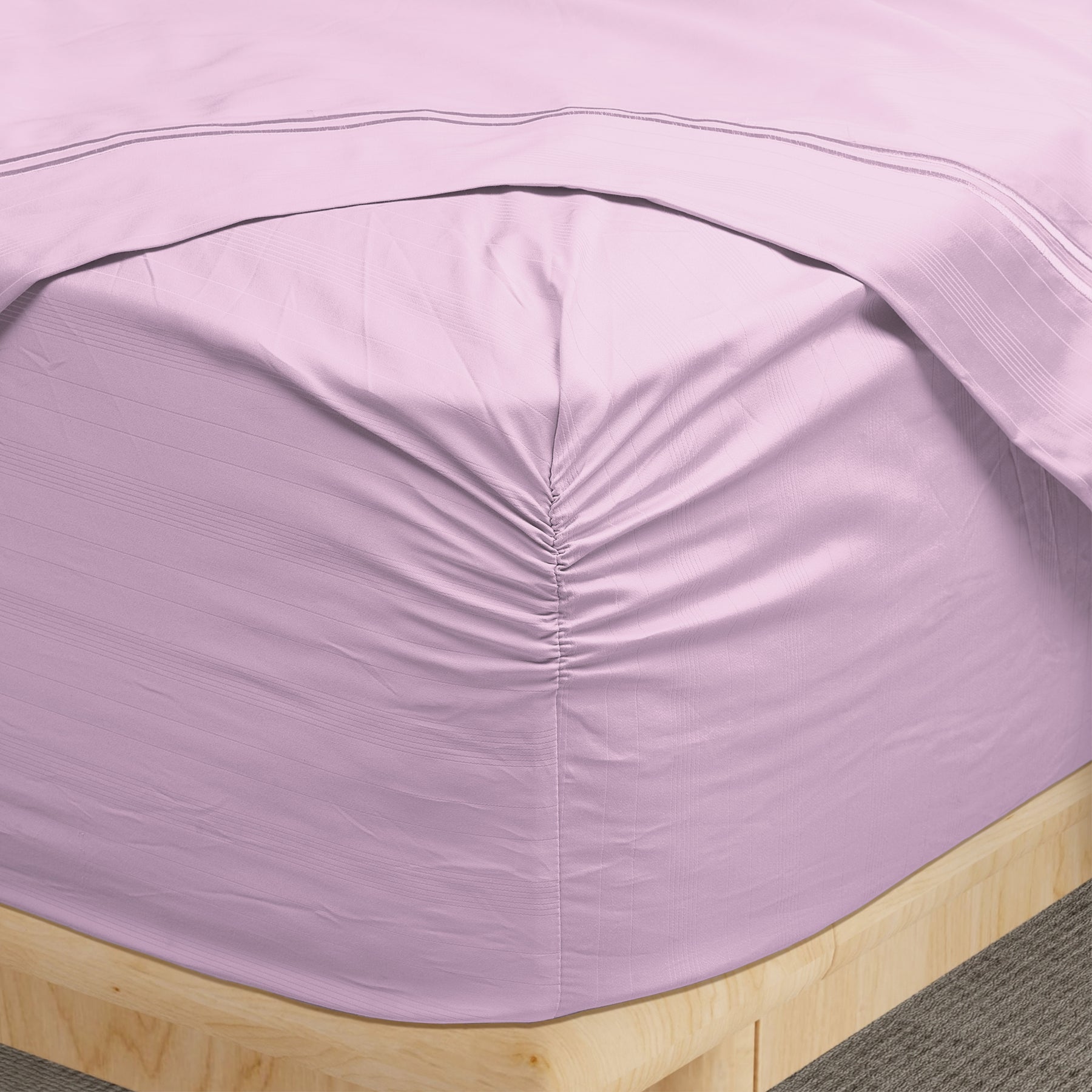 Image of a corner of a Lilac Bamboo Rayon fitted sheet showcasing the Precision-Fit® Corner