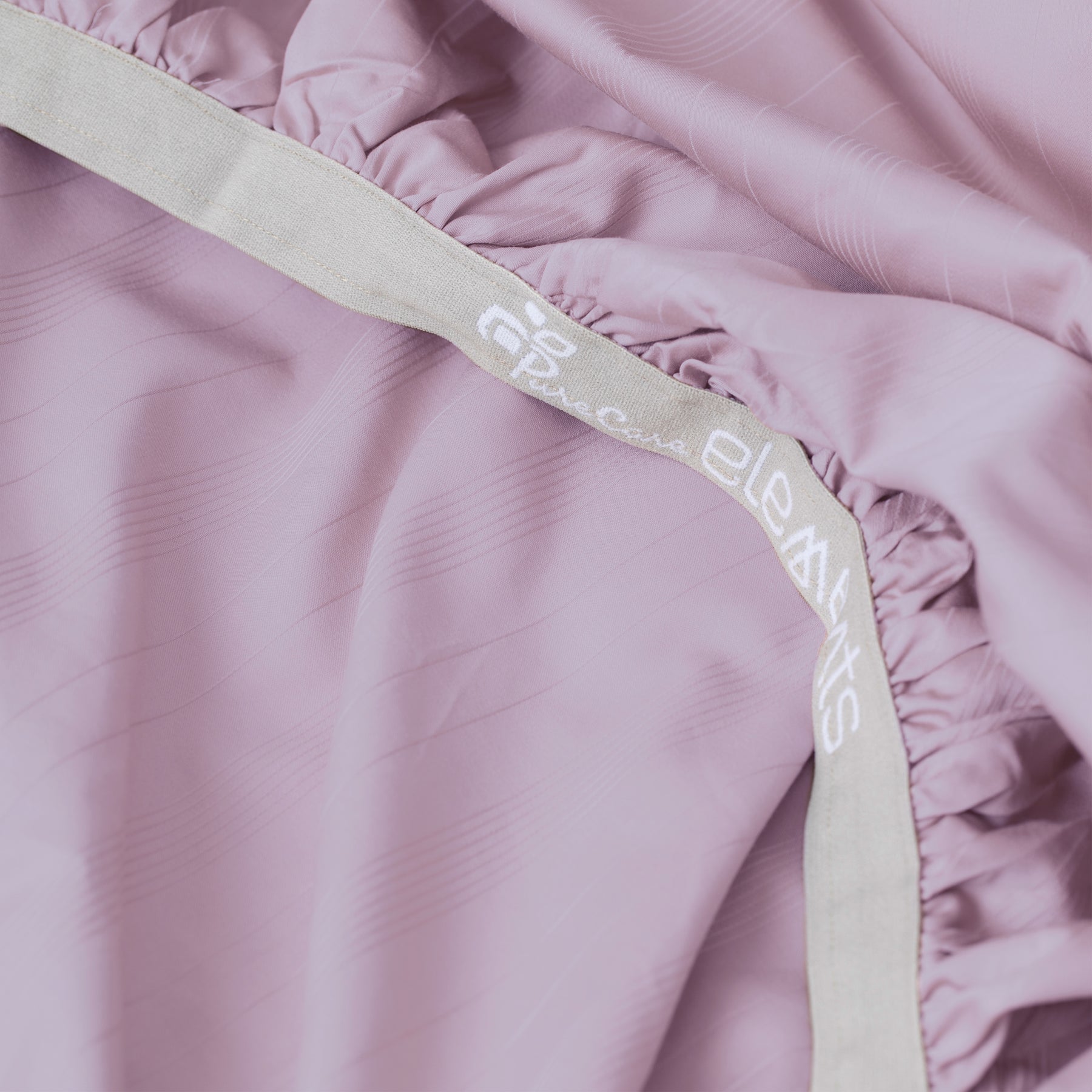 Image showcasing the Precision-Fit® elastic band on the bottom of a Lilac Bamboo Rayon fitted sheet