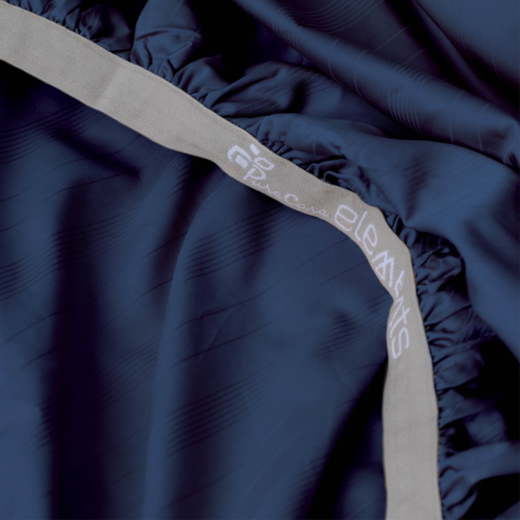 Image showcasing the Precision-Fit® elastic band on the bottom of a Midnight Bamboo Rayon fitted sheet