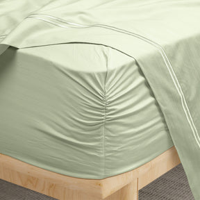 Image of a corner of a Sage Bamboo Rayon fitted sheet showcasing the Precision-Fit® Corner