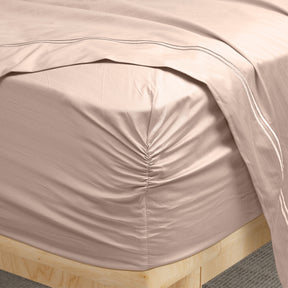 Image of a corner of a Sand Bamboo Rayon fitted sheet showcasing the Precision-Fit® Corner