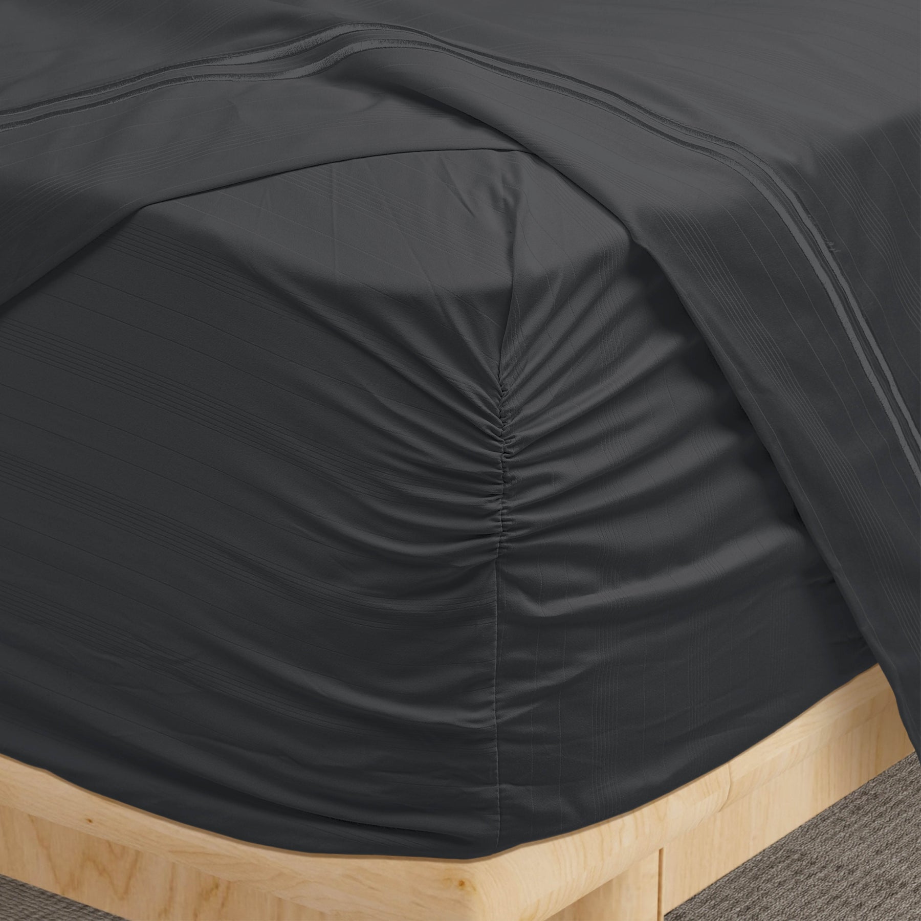 Image of a corner of a Shadow Bamboo Rayon fitted sheet showcasing the Precision-Fit® Corner