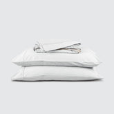 Image of White Bamboo Rayon Sheet Set stacked top to bottom: Flat Sheet, Fitted Sheet, 2 Pillowcases