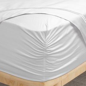 Image of a corner of a White Bamboo Rayon fitted sheet showcasing the Precision-Fit® Corner