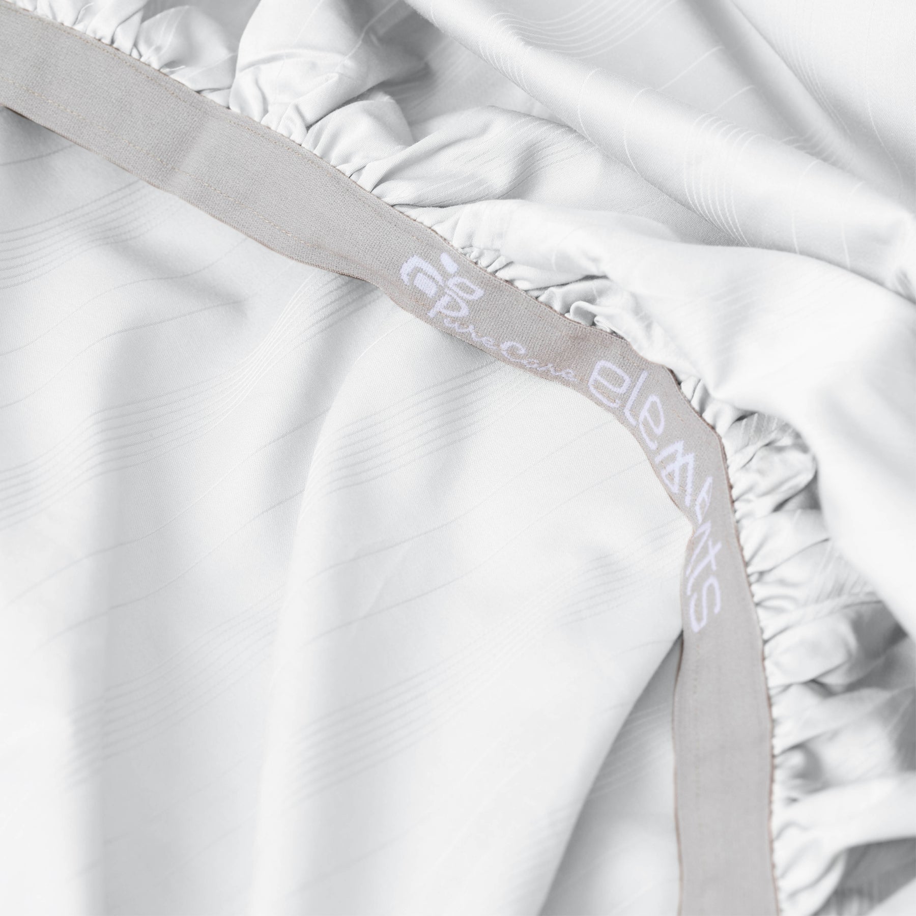 Image showcasing the Precision-Fit® elastic band on the bottom of a White Bamboo Rayon fitted sheet