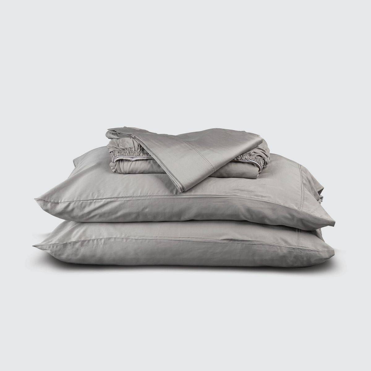 Image of Dove Gray Recovery Viscose Sheet Set stacked top to bottom: Flat Sheet, Fitted Sheet, 2 Pillowcases