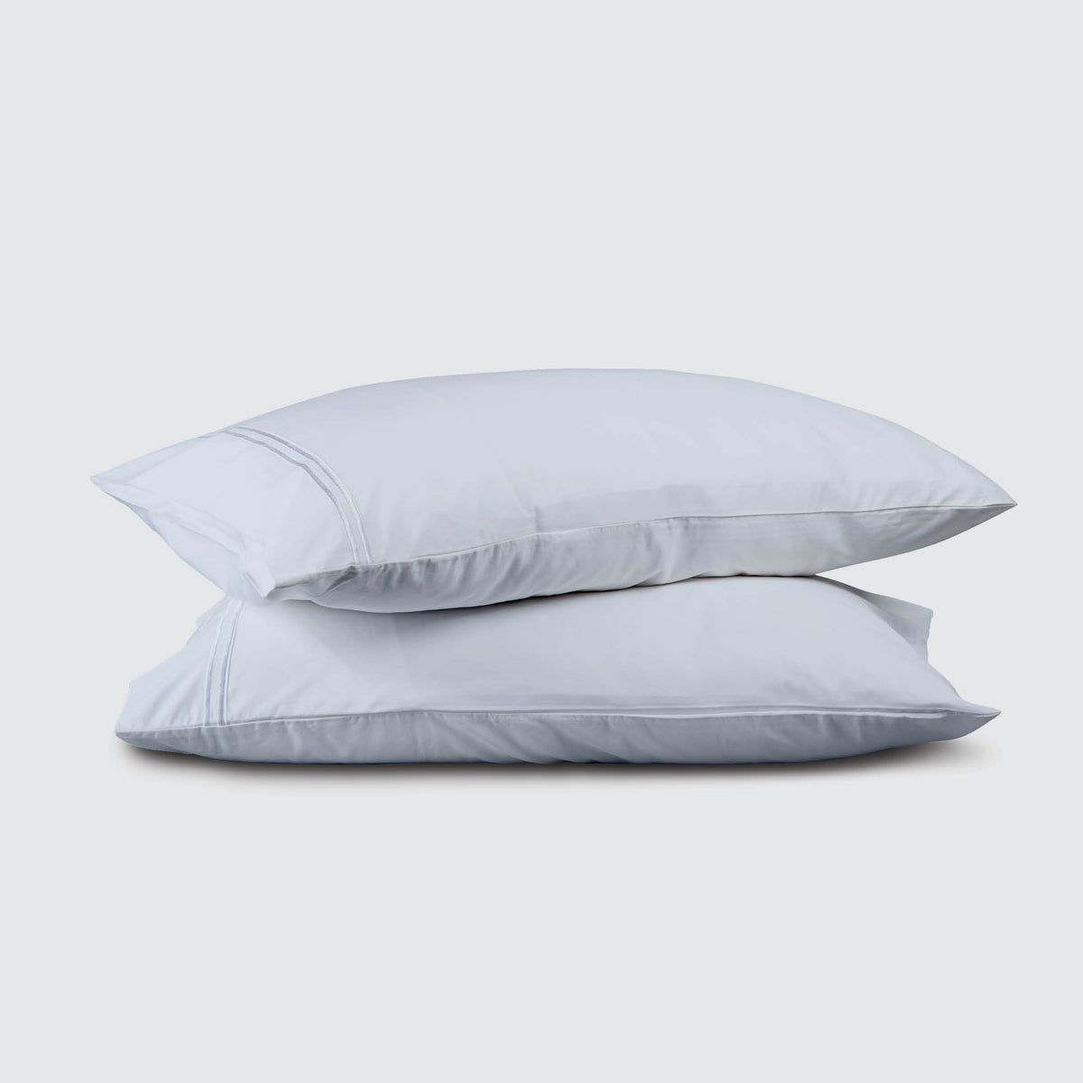 Image of two pillows stacked on top of one another with a Light Blue Refreshing TENCEL™ Lyocell Pillowcase on each