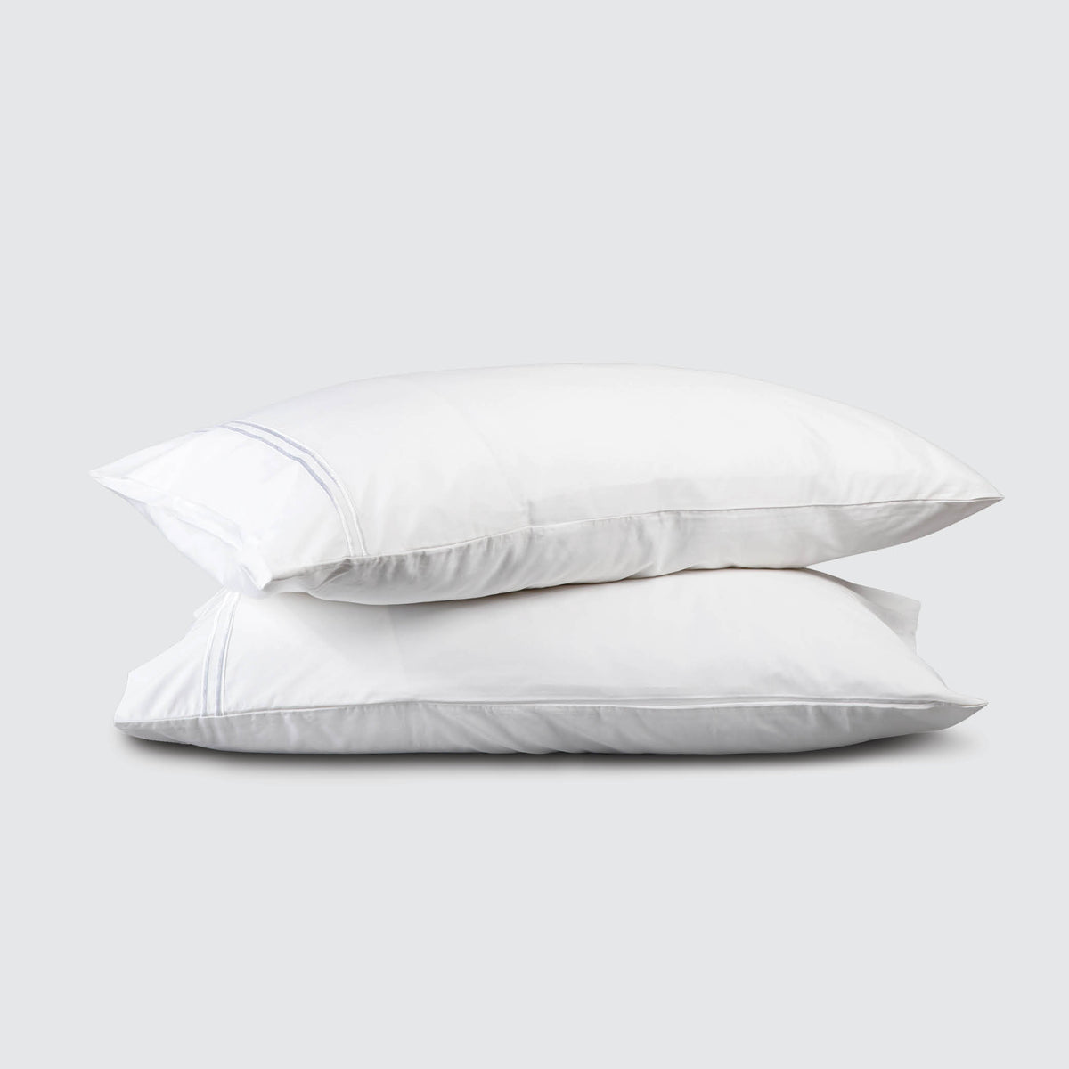 Image of two pillows stacked on top of one another with a White Refreshing TENCEL™ Lyocell Pillowcase on each