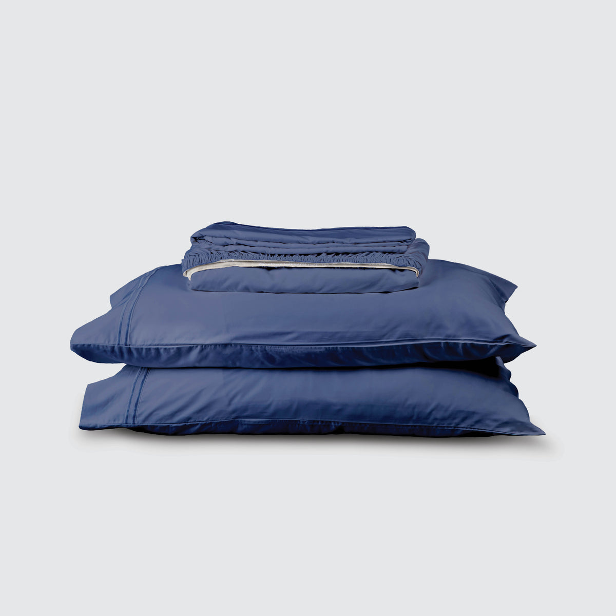 Image of Celestial Blue Refreshing TENCEL™ Lyocell Sheet Set stacked top to bottom: Flat Sheet, Fitted Sheet, 2 Pillowcases