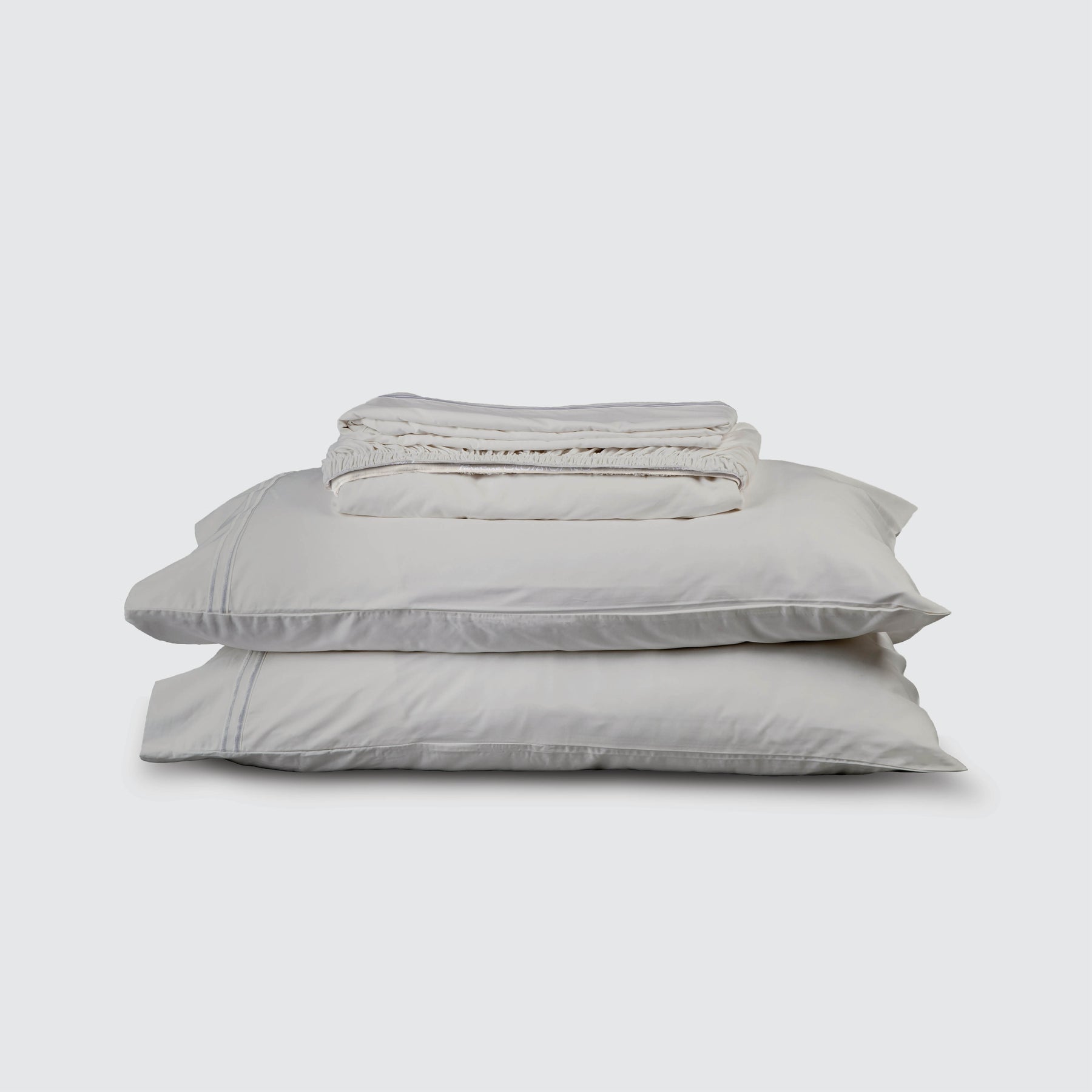 Image of Dove Gray Refreshing TENCEL™ Lyocell Sheet Set stacked top to bottom: Flat Sheet, Fitted Sheet, 2 Pillowcases