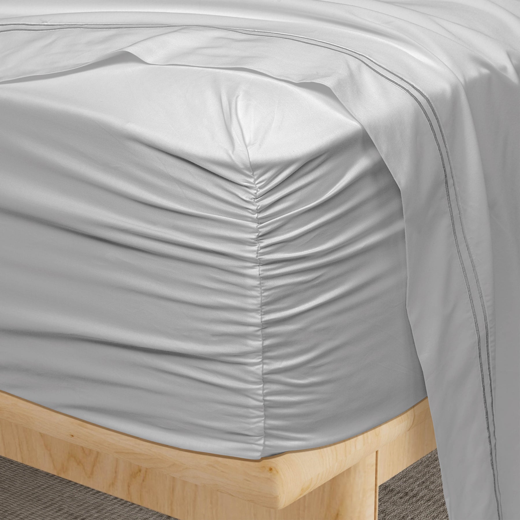 Image of a corner of a Dove Gray Refreshing TENCEL™ Lyocell fitted sheet showcasing the Precision-Fit® Corner