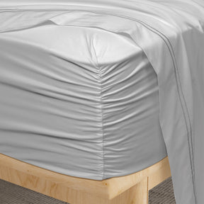 Image of a corner of a Dove Gray Refreshing TENCEL™ Lyocell fitted sheet showcasing the Precision-Fit® Corner