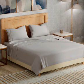 Image of a bedroom with a dressed bed with Dove Gray Refreshing TENCEL™ Lyocell Sheets 