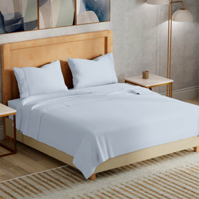 Image of a bedroom with a dressed bed with Light Blue Refreshing TENCEL™ Lyocell Sheets 