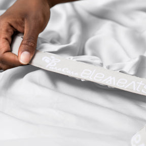 Image showcasing the Precision-Fit® elastic band on the bottom of a White Refreshing TENCEL™ Lyocell fitted sheet