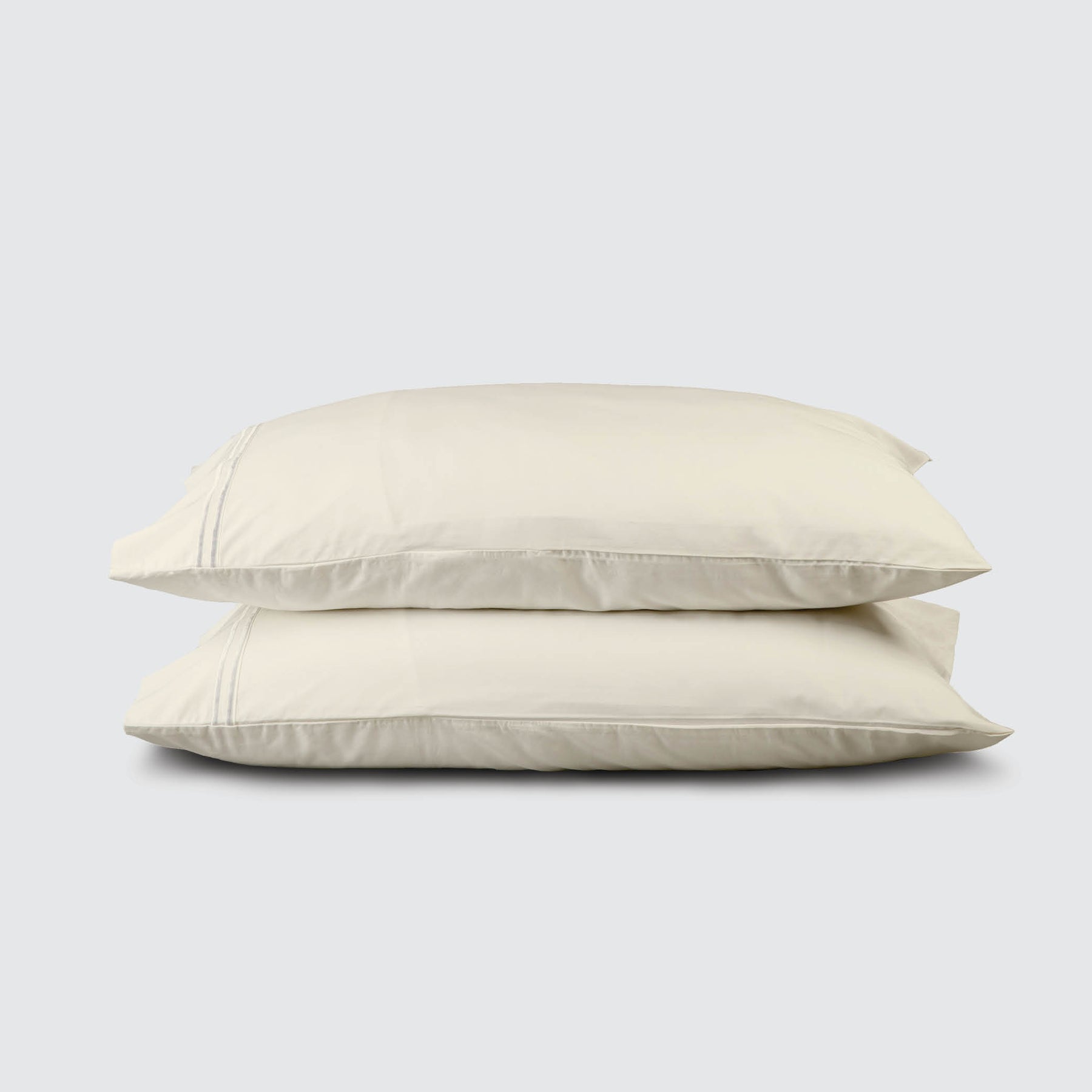 Image of two pillows stacked on top of one another with an Ivory Soft Touch TENCEL™ Modal Pillowcase on each