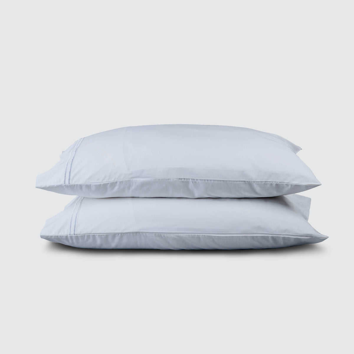 Image of two pillows stacked on top of one another with a Light Blue Soft Touch TENCEL™ Modal Pillowcase on each