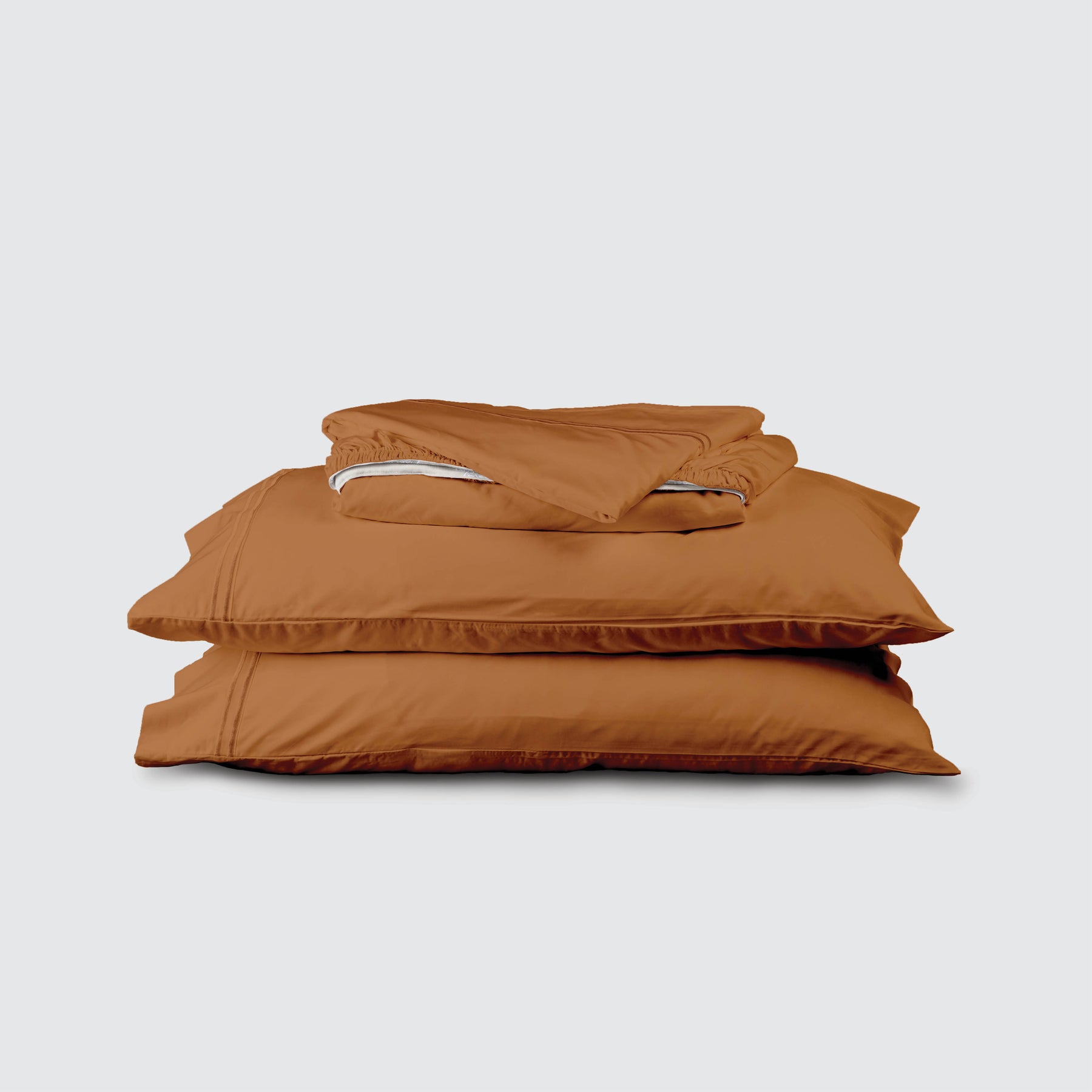 Image of Clay Soft Touch TENCEL™ Modal Sheet Set stacked top to bottom: Flat Sheet, Fitted Sheet, 2 Pillowcases