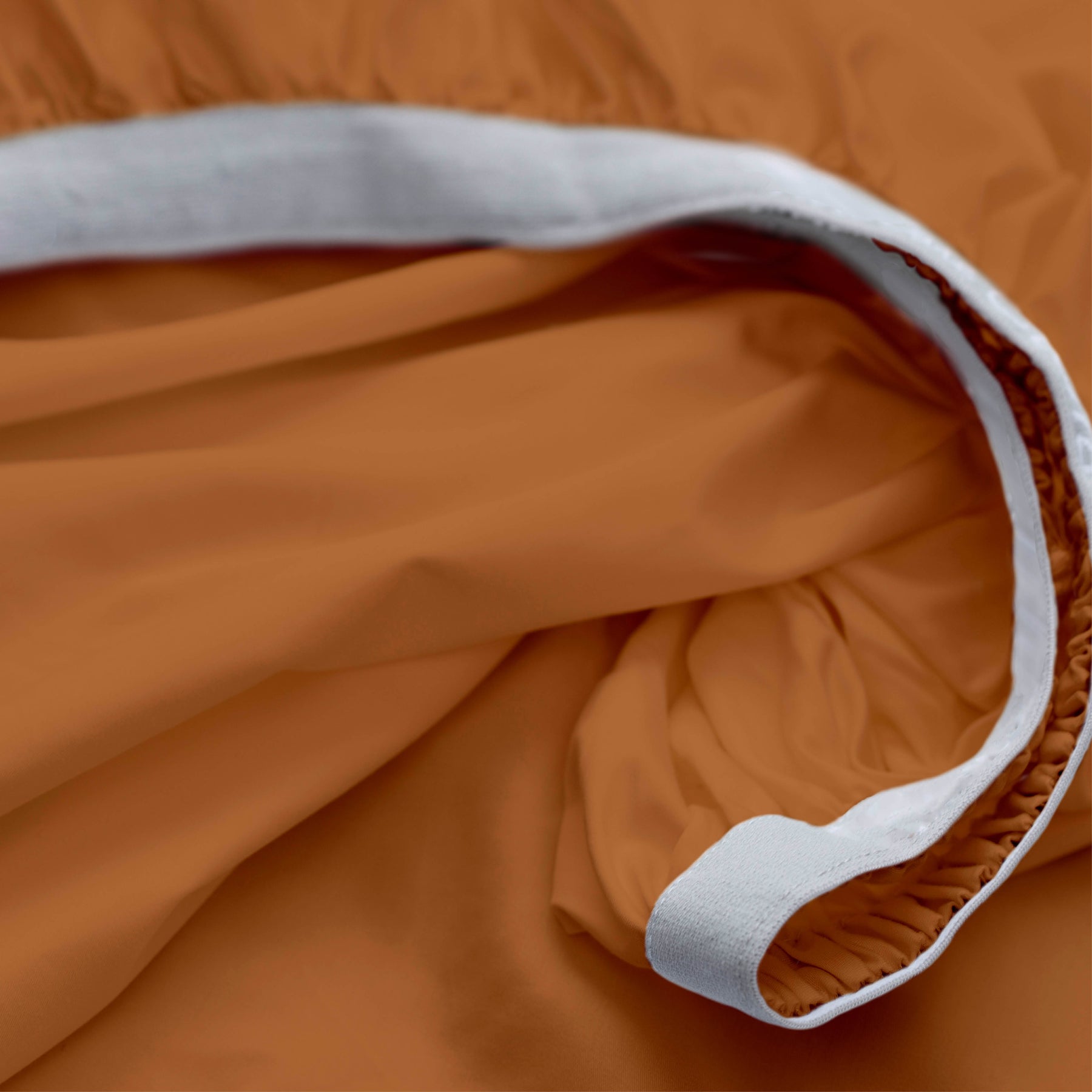 Image showcasing the Precision-Fit® elastic band on the bottom of a Clay Soft Touch TENCEL™ Modal fitted sheet