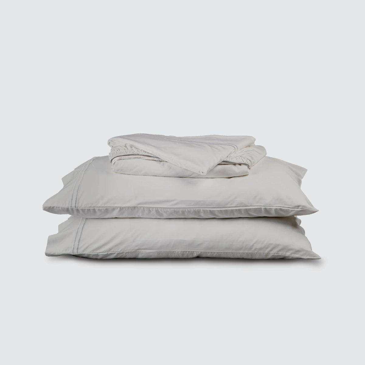 Image of Dove Gray Soft Touch TENCEL™ Modal Sheet Set stacked top to bottom: Flat Sheet, Fitted Sheet, 2 Pillowcases