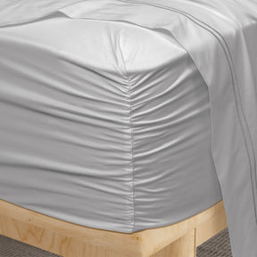 Image of a corner of a Dove Gray Soft Touch TENCEL™ Modal fitted sheet showcasing the Precision-Fit® Corner