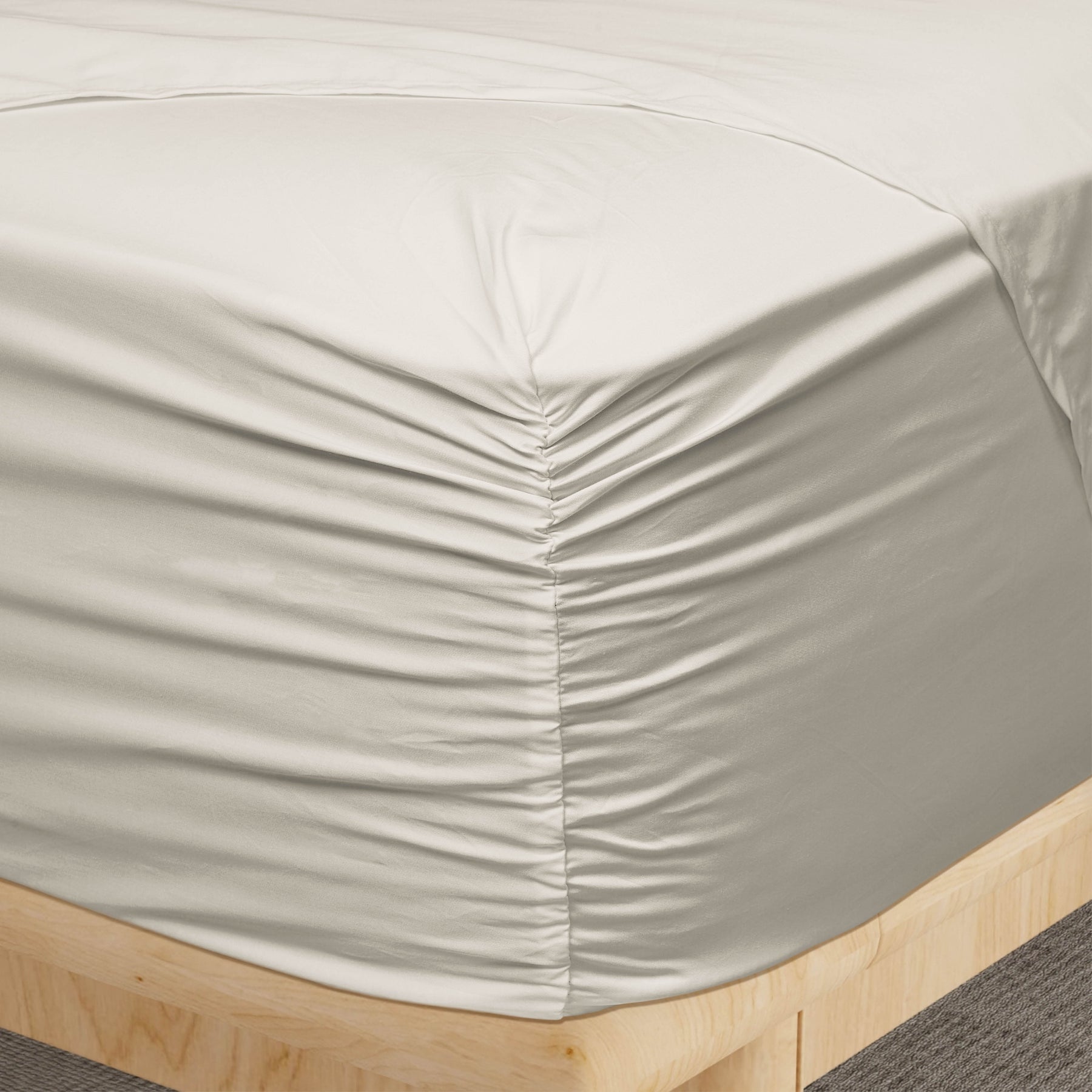 Image of a corner of an Ivory Soft Touch TENCEL™ Modal fitted sheet showcasing the Precision-Fit® Corner