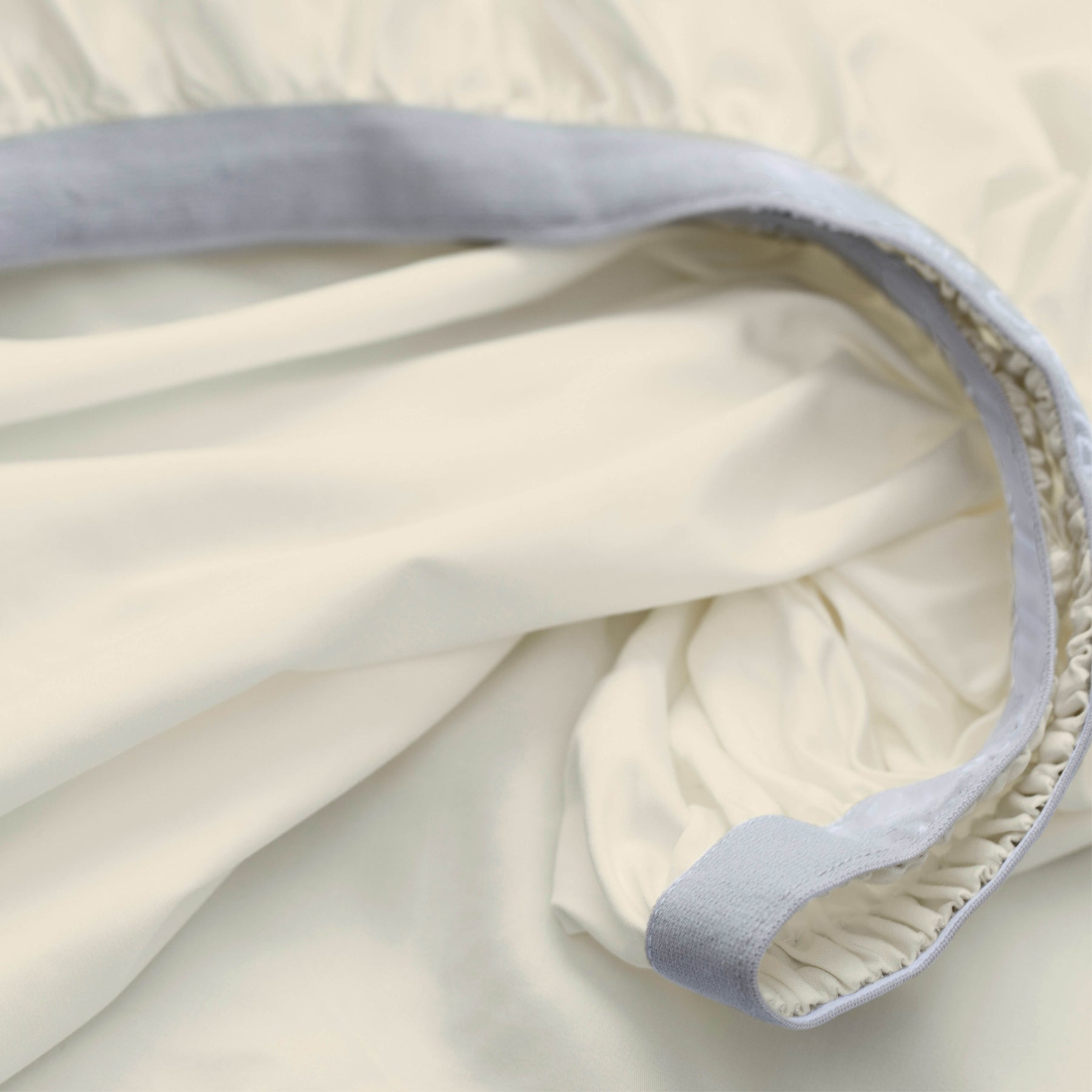 Image showcasing the Precision-Fit® elastic band on the bottom of an Ivory Soft Touch TENCEL™ Modal fitted sheet