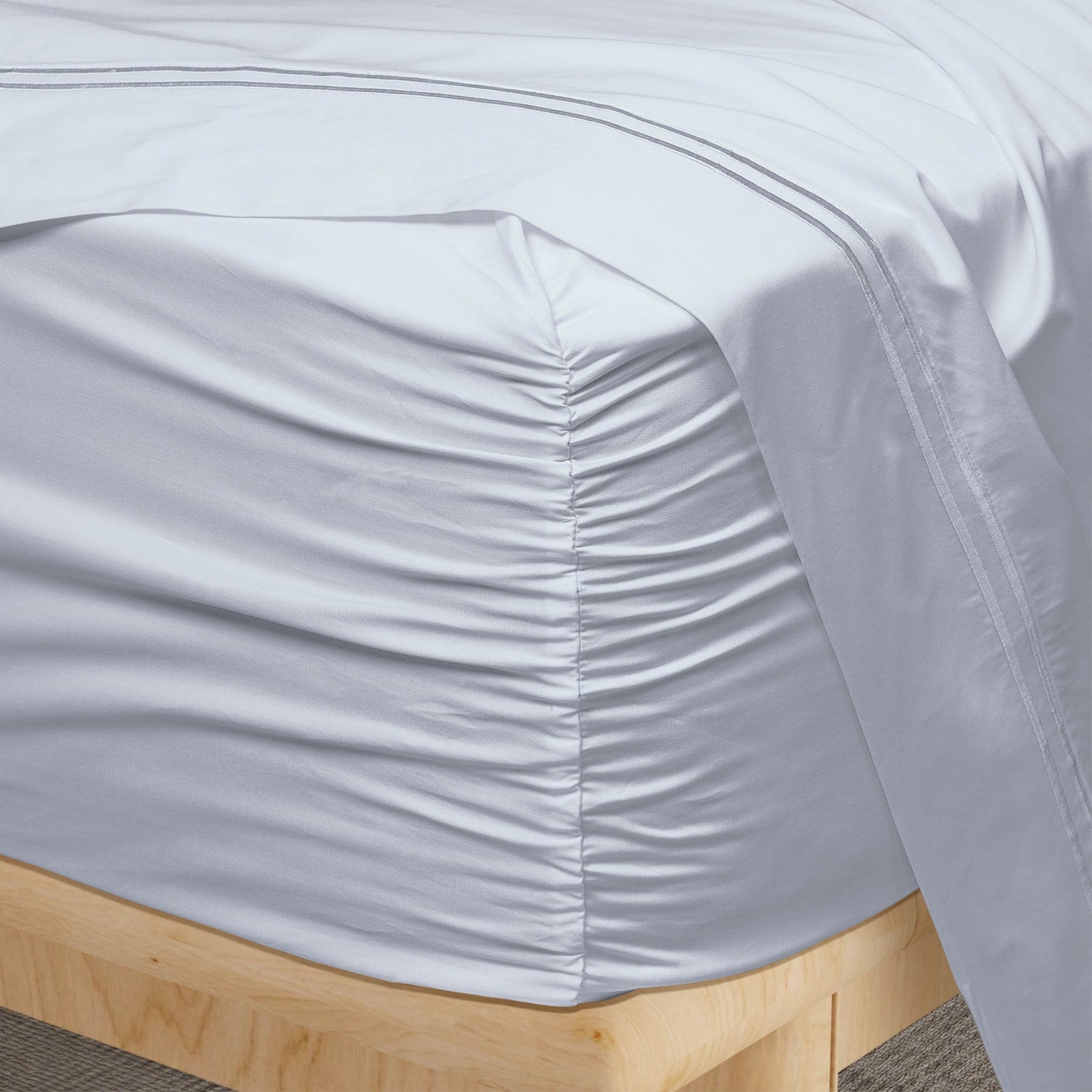 Image of a corner of a Light Blue Soft Touch TENCEL™ Modal fitted sheet showcasing the Precision-Fit® Corner