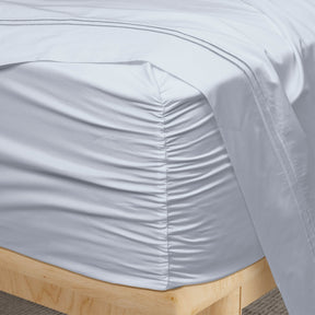 Image of a corner of a Light Blue Soft Touch TENCEL™ Modal fitted sheet showcasing the Precision-Fit® Corner