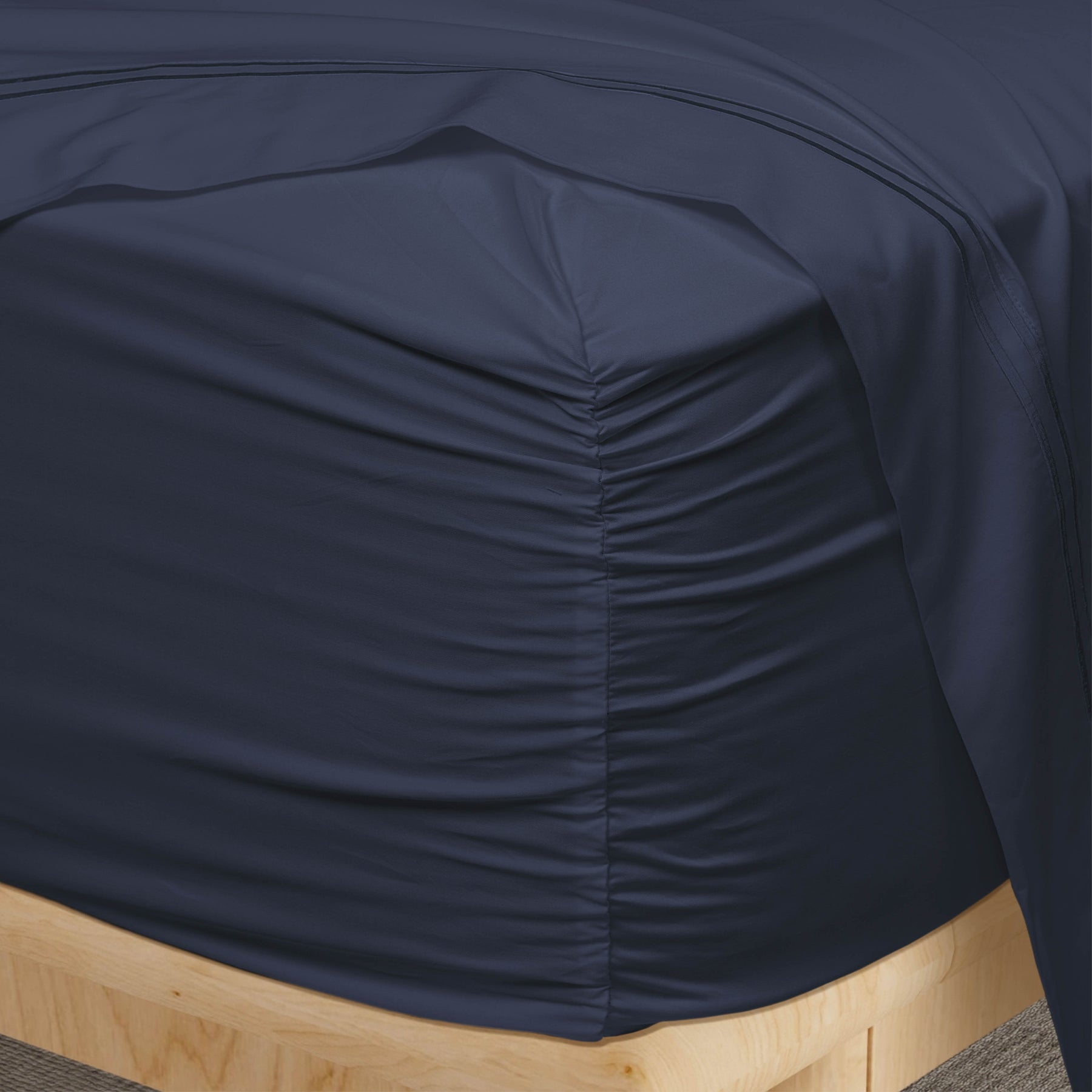 Image of a corner of a Midnight Soft Touch TENCEL™ Modal fitted sheet showcasing the Precision-Fit® Corner