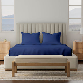 Image of a bedroom with a dressed bed with Midnight Soft Touch TENCEL™ Modal Sheets 