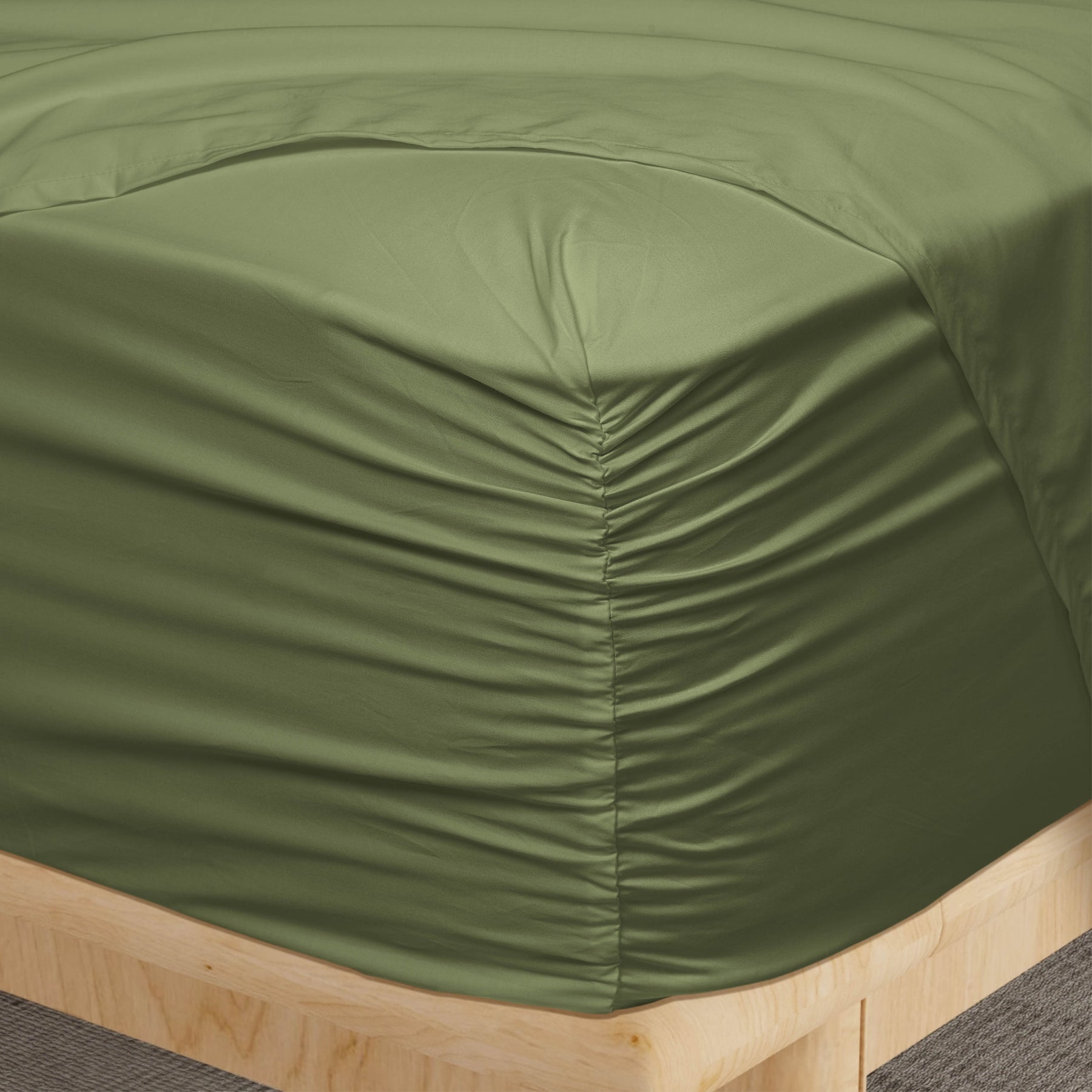 Image of a corner of a Moss Soft Touch TENCEL™ Modal fitted sheet showcasing the Precision-Fit® Corner