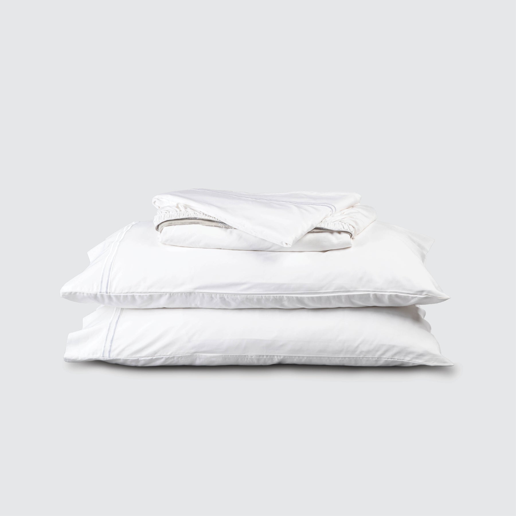 Image of White Soft Touch TENCEL™ Modal Sheet Set stacked top to bottom: Flat Sheet, Fitted Sheet, 2 Pillowcases