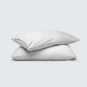 Image of two pillows stacked on top of one another with a White Weightless Cotton Pillowcase on each