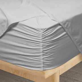 Image of a corner of a Coastal Gray Weightless Cotton fitted sheet showcasing the Precision-Fit® Corner