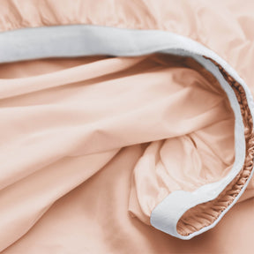 Image showcasing the Precision-Fit® elastic band on the bottom of a Blush Pink Weightless Cotton fitted sheet