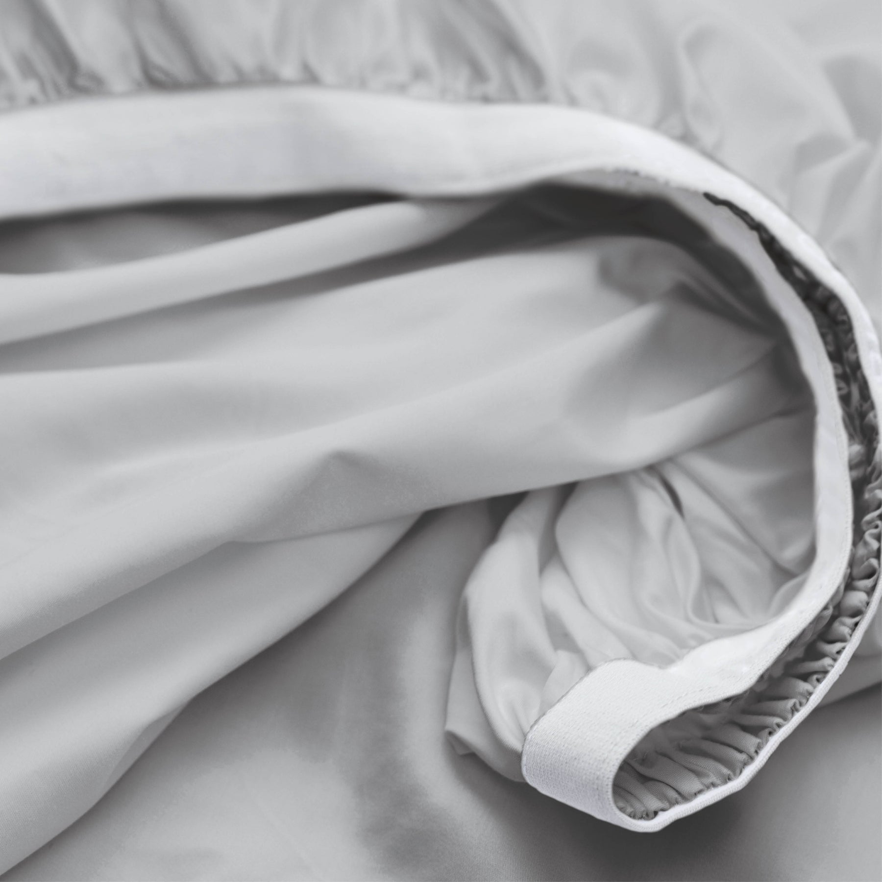 Image showcasing the Precision-Fit® elastic band on the bottom of a Coastal Gray Weightless Cotton fitted sheet