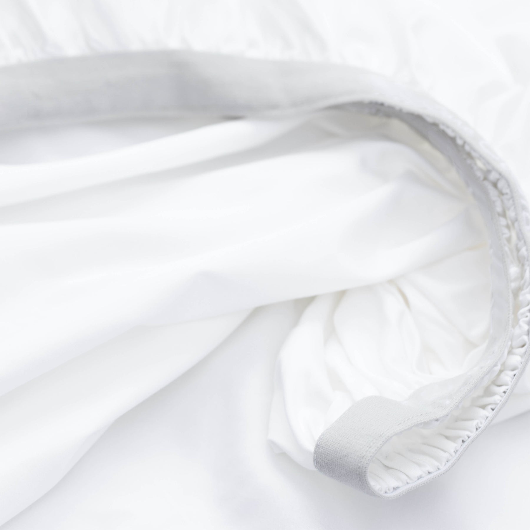 Image showcasing the Precision-Fit® elastic band on the bottom of a White Weightless Cotton fitted sheet