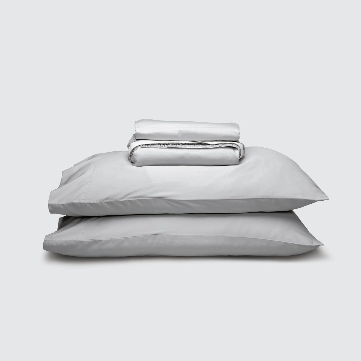 Image of Coastal Gray Weightless Cotton Sheet Set stacked top to bottom: Flat Sheet, Fitted Sheet, 2 Pillowcases