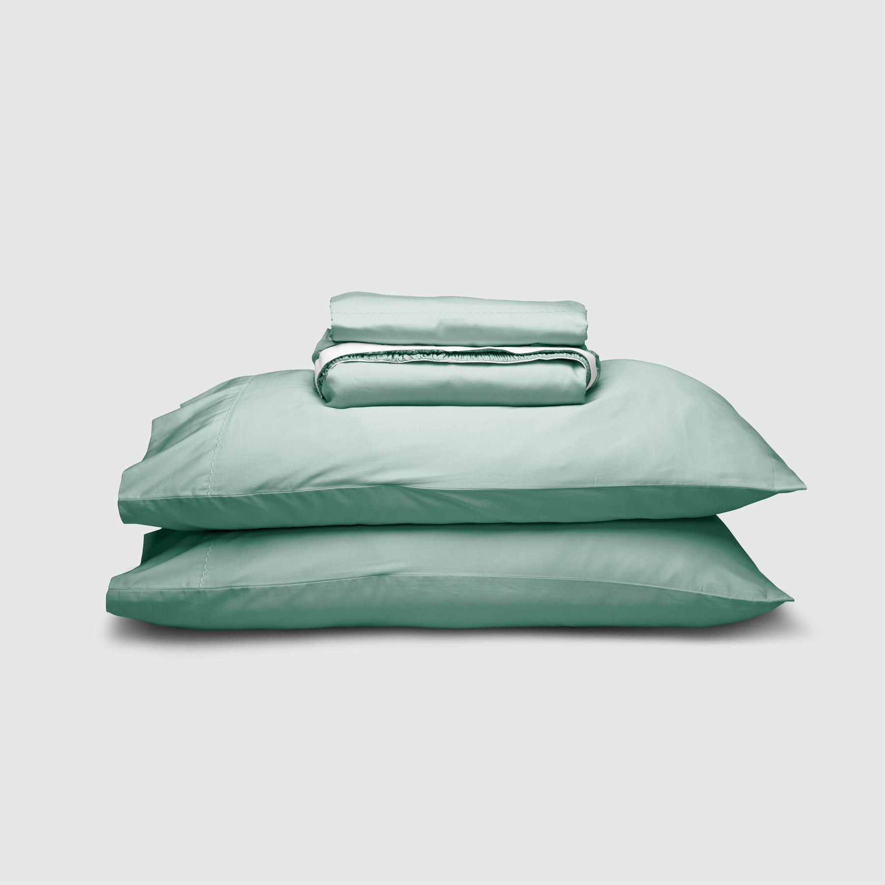 Image of Seafoam Weightless Cotton Sheet Set stacked top to bottom: Flat Sheet, Fitted Sheet, 2 Pillowcases