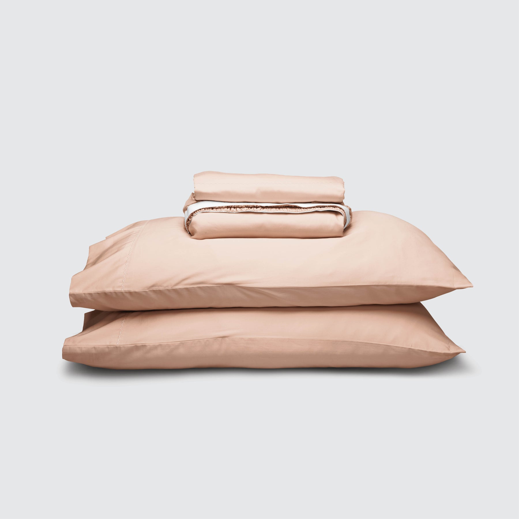 Image of Blush Pink Weightless Cotton Sheet Set stacked top to bottom: Flat Sheet, Fitted Sheet, 2 Pillowcases